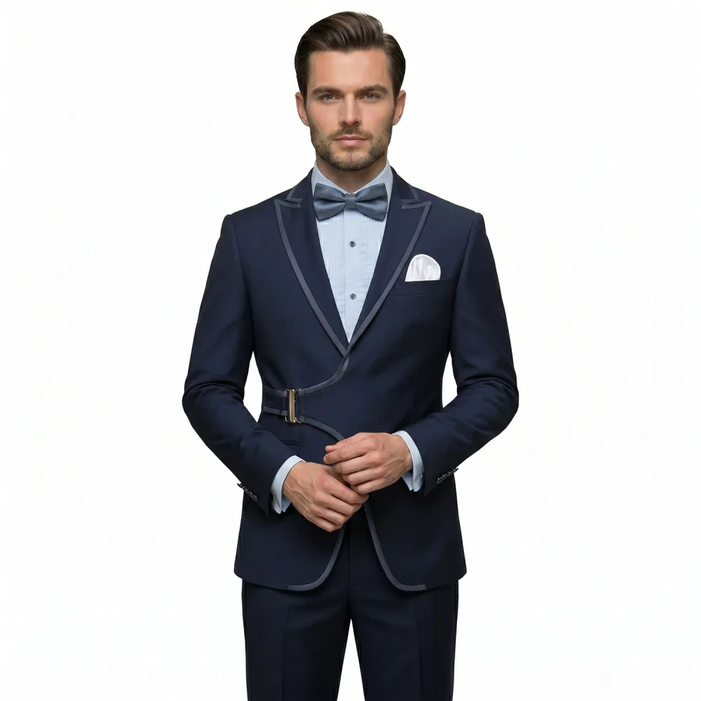 Men’s black tuxedo with satin piping, buckle detail, matching trousers, dress shirt, bow tie, and pocket square by Andre Emilio