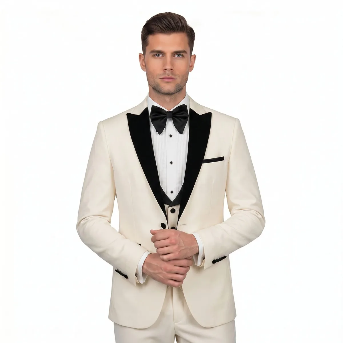 Men’s off white peak lapel tuxedo with black lapels, matching trousers, white dress shirt, black bow tie, and formal vest by Andre Emilio