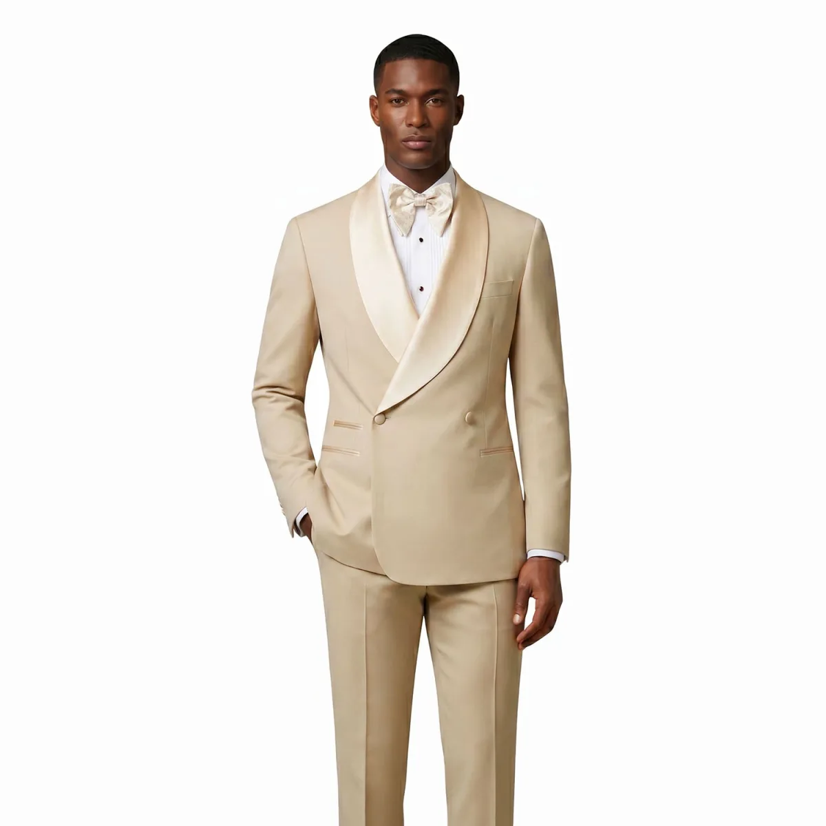 Men’s beige double breasted tuxedo with satin shawl lapel, matching trousers, white dress shirt, and beige bow tie by Andre Emilio
